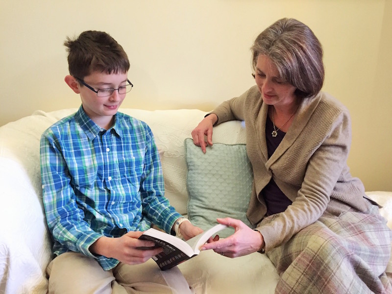 Educational Psychologist reading with boy